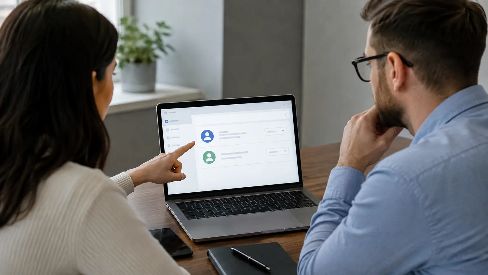 Business owner and agency specialist reviewing owner and manager permissions in an advertising account